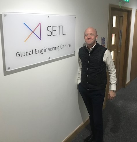 Steve Walsh Coo stands next to the SETL engineering sign.